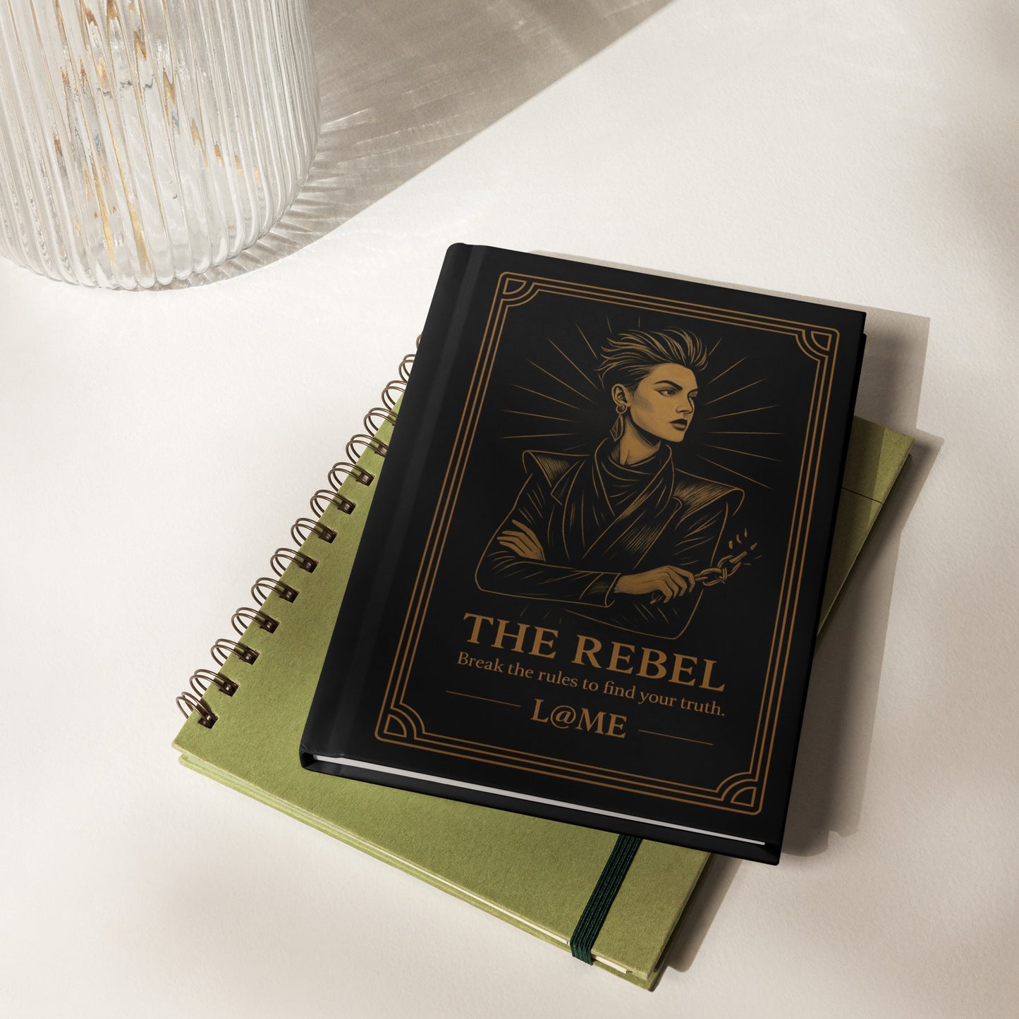 Matte hardcover journal with gold "Rebel" tarot artwork on black, 5.75 by 8 inches.